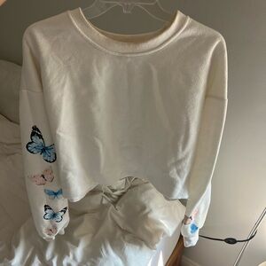 White crewneck with butterfly design and open hem, women’s size M